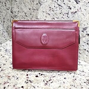 CARTIER Clutch  beautiful burgundy belongs to the "Must de Cartier Collection